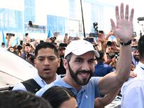 Salvadoran President Nayib Bukele greets supporters on his arrival at a polling station to cast his vote during the presidential and legislative elections in San Salvador on February 4, 2024. (Photo by YURI CORTEZ / AFP)